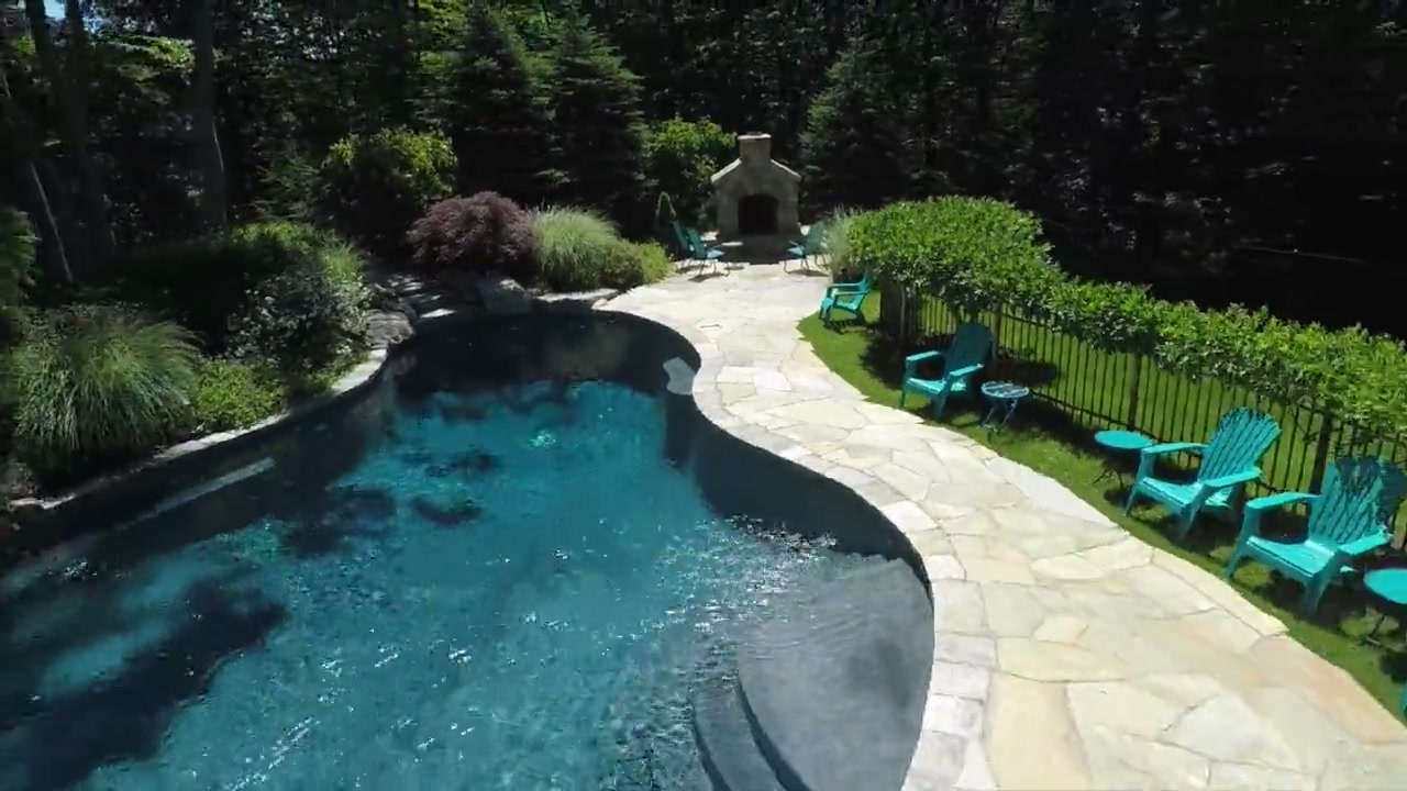 Backyard pool and stone patio from above