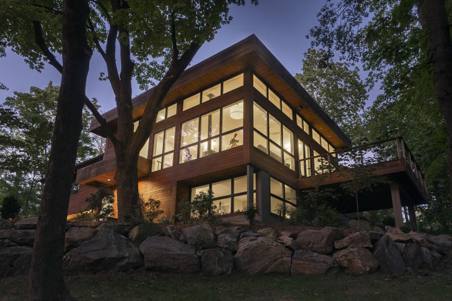 Modern glass house at dusk